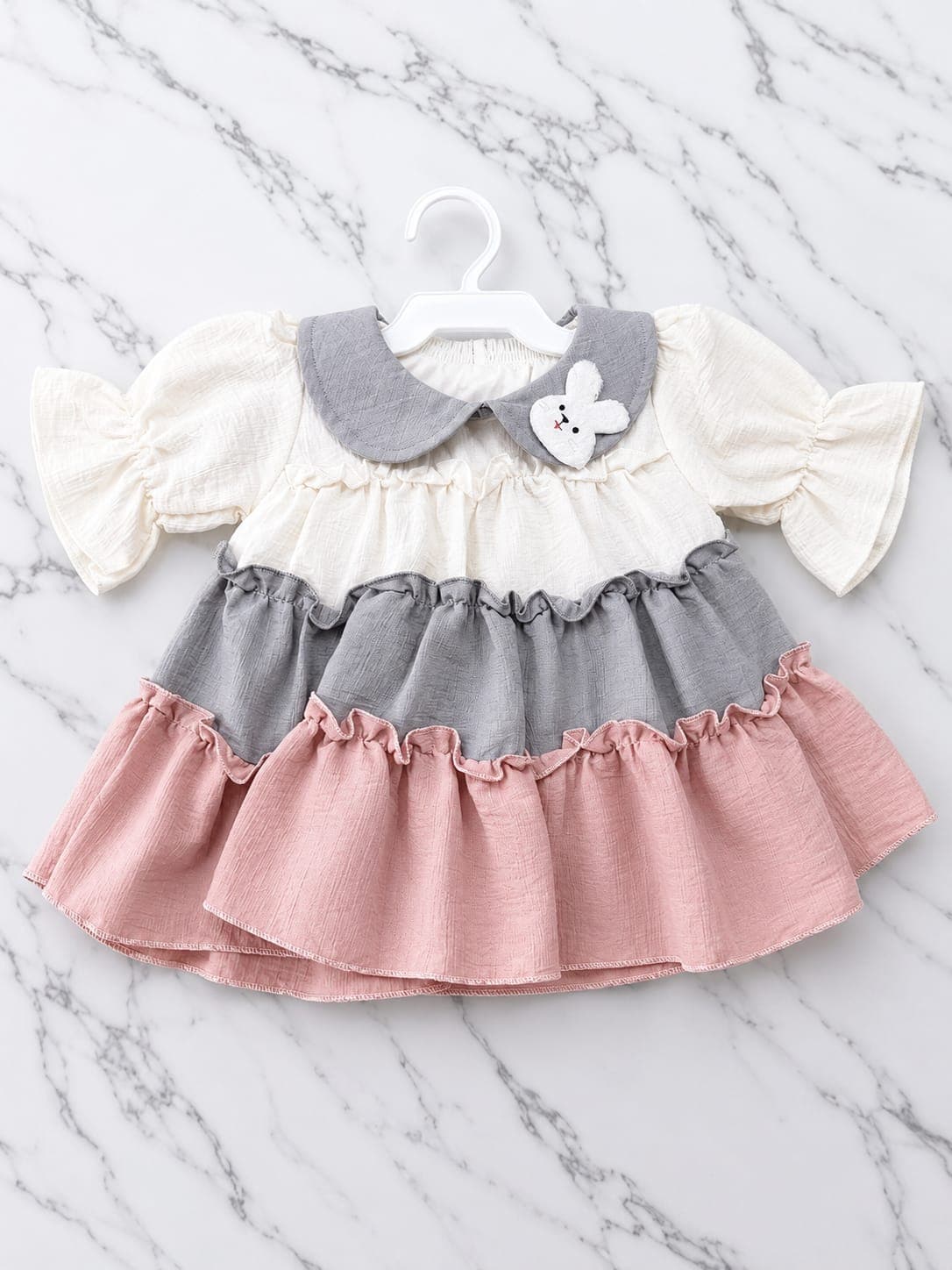 Cream, grey, and dusty rose tiered baby dress with bunny appliqué