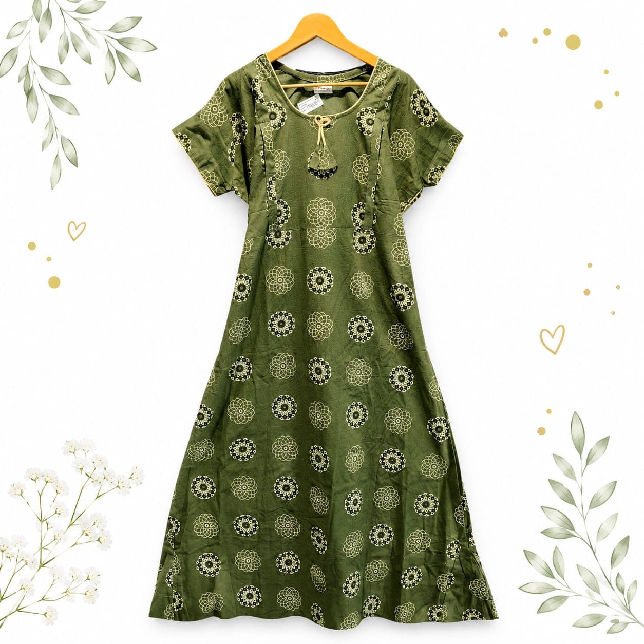 Olive green patterned dress on a wooden hanger